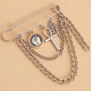 Punk style multi-layered chain brooch with rose, coin and cross charms on a silver pin