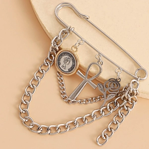 Detailed view of punk brooch with rose, Ankh cross, and Queen Elizabeth coin charms