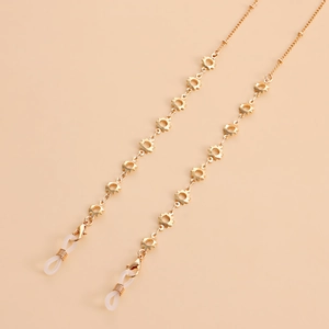 Chaîne de lunettes dorée avec pendentifs soleil évidés et boucles en silicone pour masques