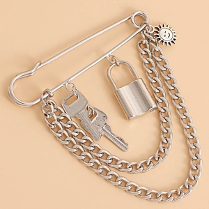 Punk style silver safety pin brooch with hanging cuban chains, padlock and key charms