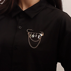 Gold-tone safety pin brooch with LOVE heart pendants and butterfly tassel on clothing
