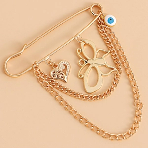 Broche papillon punk avec pampilles, œil bleu et chaînes dorées pour femmes