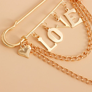 Gold-tone safety pin brooch with LOVE letters heart charms and tiered curb chains