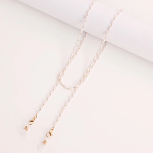 Elegant white pearl eyewear chain with gold metal links and anti-slip silicone loops