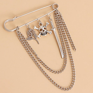 Silver gothic brooch pin with skull, rose, and dagger charms featuring long chain tassels