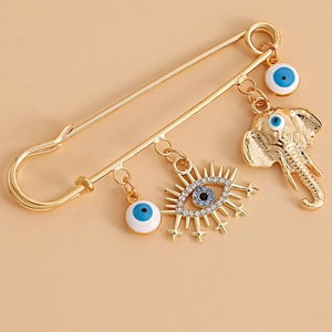 Vintage golden safety pin brooch featuring blue evil eye charms and a sun eye pendant