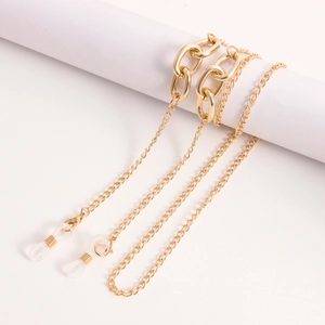 Detailed macro of golden metal eyeglass chain with anti-slip silicone loop connectors