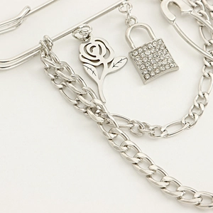Detailed macro view of the silver punk rose pendant with rhinestone padlock and metal chains