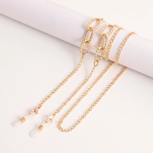 Detail of gold metal glasses chain with textured link design and silicone ends