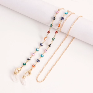 Detail of colorful Evil Eye beads on golden metal glasses chain with non-slip loops