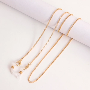 Close-up of gold glasses chain with lobster clasps and white silicone connectors
