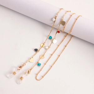 Detail view of golden eyewear chains with colorful enamel hearts and secure rubber loops