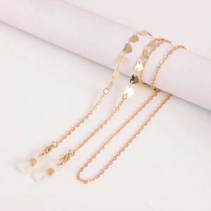 Detail of golden heart charm eyeglasses chain with lobster clasp and silicone loop