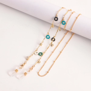 Detail of golden eyewear chain with colorful enamel rings and lobster clasps on white background