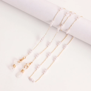 Elegant gold chain eyewear holder with white pearls and rubber loops for glasses