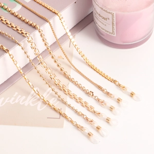 Detailed set of gold metal eyewear chains with lobster clasps and silicone loops