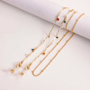 Detail of gold chain eyewear strap with colorful beads and transparent silicone loops