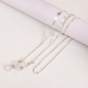 Detail of silver metal glasses chain featuring heart charms and silicone loops