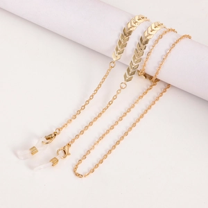 Detail of gold metal glasses chain with arrow feather charms and adjustable silicone loops