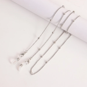 Silver metal glasses chain with polished beads and silicone loops shown on a white spool
