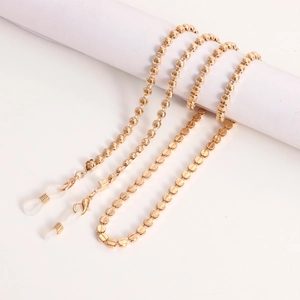Detailed close-up of golden metal bead chain with silicone loops for glasses and masks