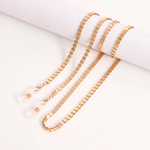 Detailed close-up of golden box chain for glasses with lobster clasp and silicone loop