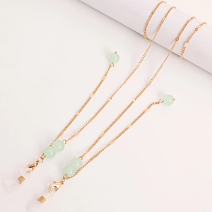 Detail of gold chain with green stone beads and adjustable anti-slip silicone loops