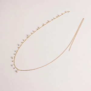Detail of gold metal waist chain featuring pearls, rhinestones and lobster clasp