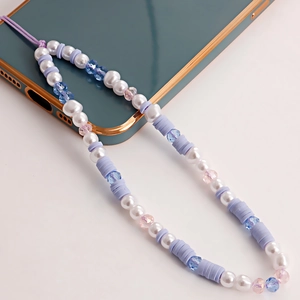 Purple handmade beaded phone charm strap with pearls and soft clay discs on mobile phone