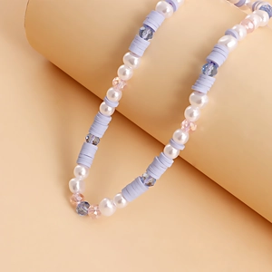 Detail of colorful beaded phone strap with white pearls and purple faceted crystals
