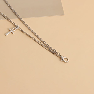 Detail of silver double-layer punk waist chain with a mini geometric Ankh cross pendant