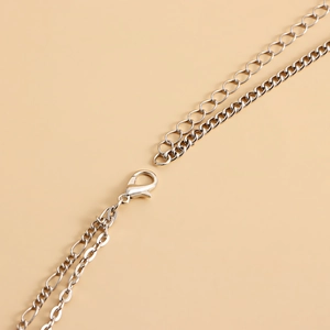 Detailed close-up of the silver metal lobster clasp and adjustable layered chains
