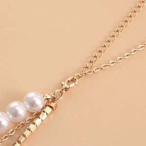 Chic multi-layer waist chain with large faux pearls and gold lobster clasp detail