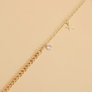 Detail of gold waist chain with star pendant and clear faceted crystal stones