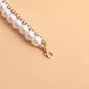 Detail of layered waist chain with white pearls, gold rhinestones and a lobster clasp