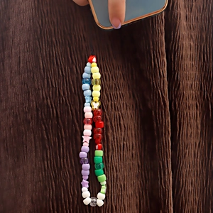Colorful handmade beaded phone charm featuring star and heart shapes on a phone case