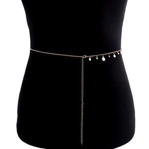 Elegant gold metal waist chain with faux pearls and zircon tassels on black mannequin