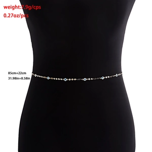 Gold geometric waist chain for women with blue and white evil eye charms on black mannequin