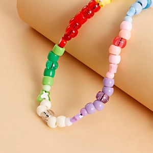 Macro shot of colorful acrylic beads and star patterns on a versatile mobile phone charm strap