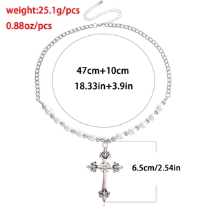 Retro multilayer necklace with silver cross pendant and pearls on white background
