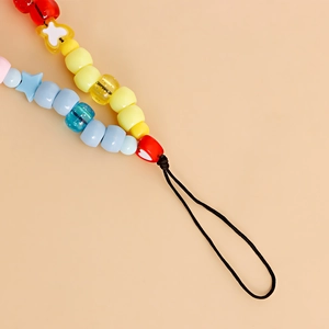 Close-up of colorful beaded phone strap with acrylic heart and star shapes