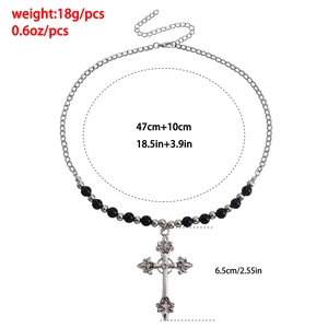 Detail view of vintage cross necklace with black beads and dimension markings