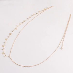 Detailed close-up of golden layered butterfly waist chain with sparkling zircons and lobster clasp