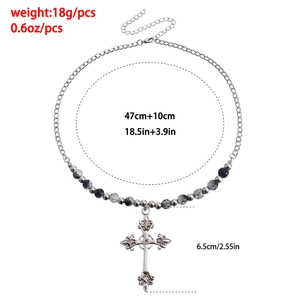 Detail view of retro cross pendant necklace with size labels and beaded chain details