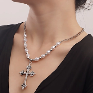 Detailed macro view of the vintage hollow cross pendant and mixed pearl chain texture