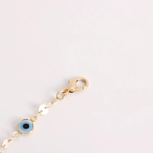 Macro view of gold evil eye waist chain with flat round sequins and lobster clasp
