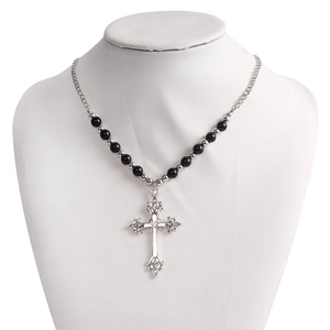 Detailed close-up of retro gothic cross pendant with black beads on a silver necklace