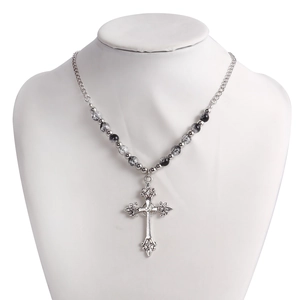 Detail of beaded necklace showing silver cross pendant and grey marble beads on a bust