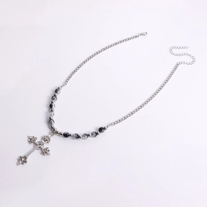 Detail of vintage gothic cross necklace with silver chain and grey marble beads