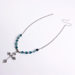 Detailed view of vintage engraved cross pendant with turquoise beads and silver chain
